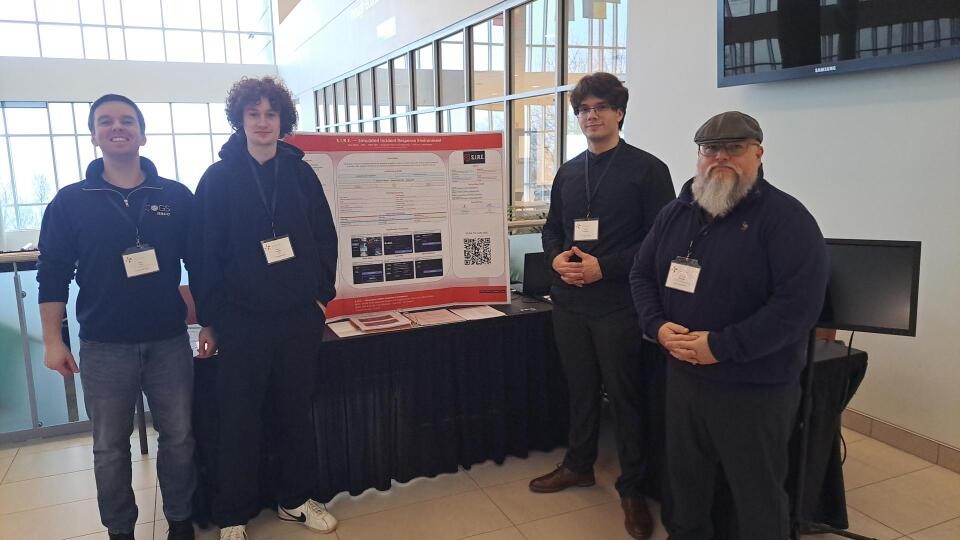 S.I.R.E. team at NSCC IT Showcase — four-person team presenting to industry guests